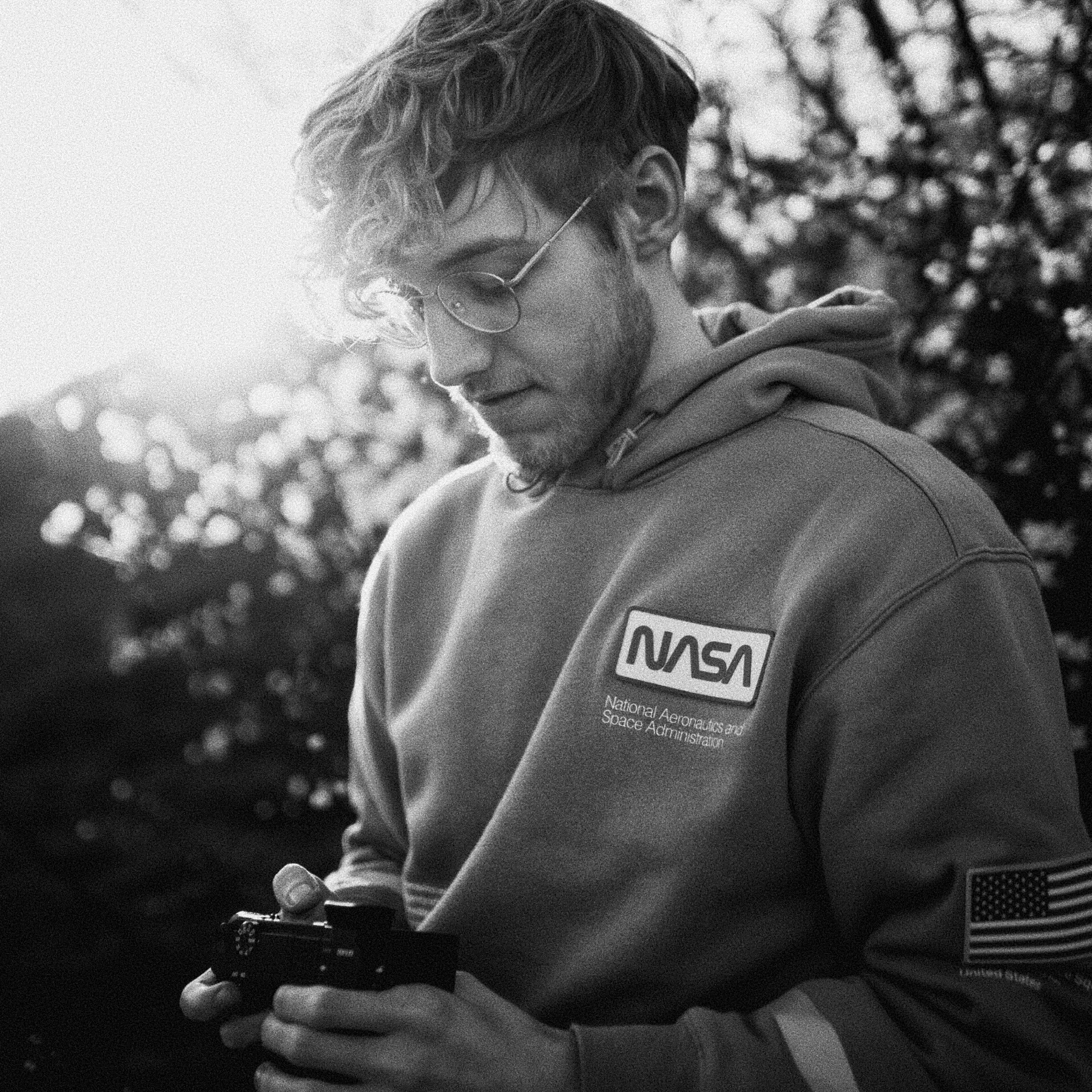 Male person holding a camera outdoors